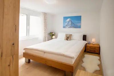 Ein Bett oder Betten in einem Zimmer der Unterkunft Casa delle Stelle by Zermatt Premium Apartments