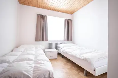 Ein Bett oder Betten in einem Zimmer der Unterkunft Valaisia 49
