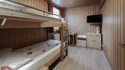 Ein Bett oder Betten in einem Zimmer der Unterkunft Rössli Holiday Apartment