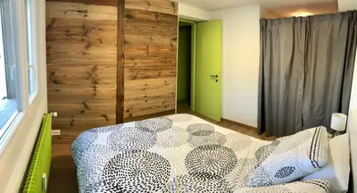 Ein Bett oder Betten in einem Zimmer der Unterkunft Anzère, appartement cozy au coeur des Alpes