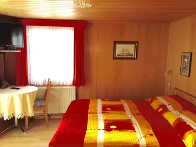 Ein Bett oder Betten in einem Zimmer der Unterkunft Hotel Haus Mühlebach