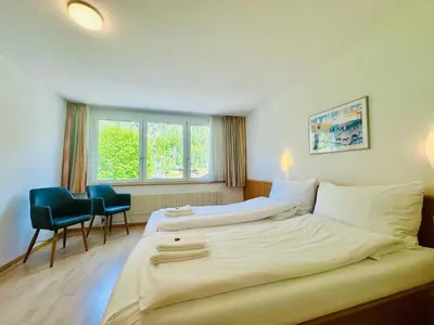 Ein Bett oder Betten in einem Zimmer der Unterkunft Hotel Rebstock Meiringen