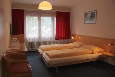 Ein Bett oder Betten in einem Zimmer der Unterkunft Hotel Eigerblick
