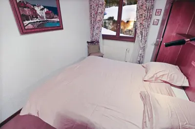 Ein Bett oder Betten in einem Zimmer der Unterkunft Charmant appartement avec vue sur les montagnes