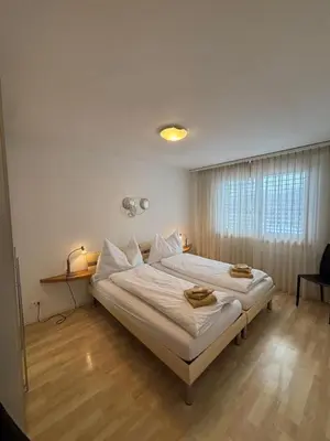 Ein Bett oder Betten in einem Zimmer der Unterkunft Grindelwald Swiss Vacances