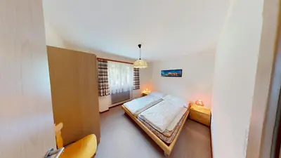 Ein Bett oder Betten in einem Zimmer der Unterkunft Floralpina FL1