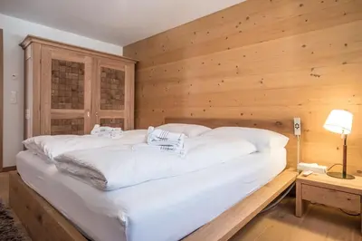 Ein Bett oder Betten in einem Zimmer der Unterkunft Apartment Bränderli 4,5 - GRIWA RENT AG