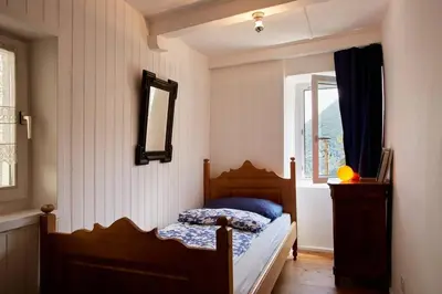 Ein Bett oder Betten in einem Zimmer der Unterkunft Wild Valley Palm Garden in Valle Onsernone