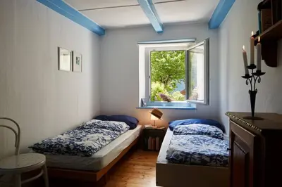 Ein Bett oder Betten in einem Zimmer der Unterkunft Wild Valley Palm Garden in Valle Onsernone