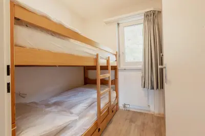 Ein Bett oder Betten in einem Zimmer der Unterkunft Appartement proche des remontées mécaniques