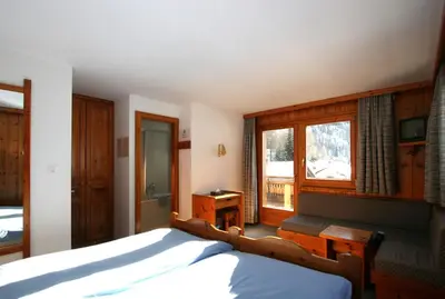 Ein Bett oder Betten in einem Zimmer der Unterkunft Hôtel Garni Les Bouquetins