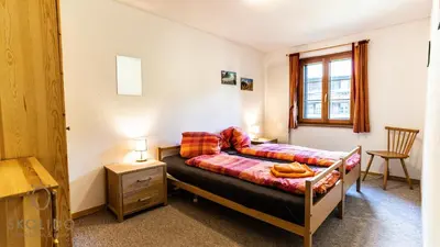 Ein Bett oder Betten in einem Zimmer der Unterkunft Ferienwohnung Haus Binelti, Fiesch