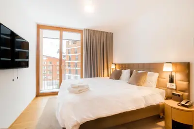 Ein Bett oder Betten in einem Zimmer der Unterkunft Gotthard Hotel Apartment
