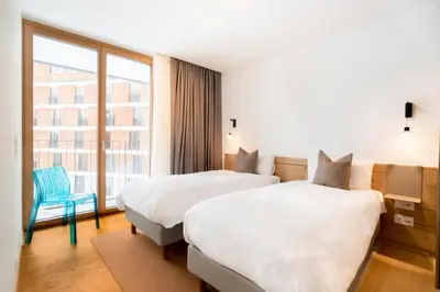 Ein Bett oder Betten in einem Zimmer der Unterkunft Gotthard Hotel Apartment