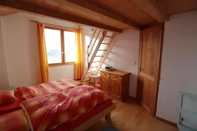 Ein Bett oder Betten in einem Zimmer der Unterkunft Chalet Les Pyramides
