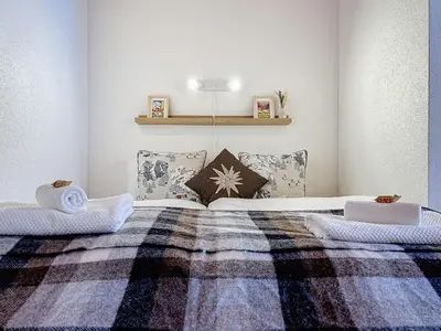 Ein Bett oder Betten in einem Zimmer der Unterkunft Appartement Wengen - Charme Alpin