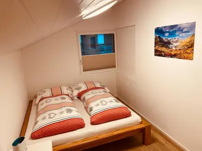 Ein Bett oder Betten in einem Zimmer der Unterkunft Ferienwohnung in Mörel