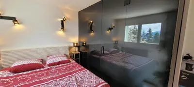 Ein Bett oder Betten in einem Zimmer der Unterkunft Chez Claudine et Charles - Crans-Montana