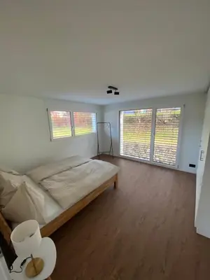 Ein Bett oder Betten in einem Zimmer der Unterkunft Abendrot- grosse moderne und stilvolle Ferienwohnung im Bergdorf Sörenberg