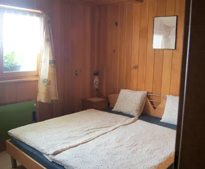 Ein Bett oder Betten in einem Zimmer der Unterkunft Fluehüsli