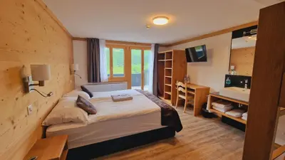 Ein Bett oder Betten in einem Zimmer der Unterkunft Berghotel Hahnenmoos