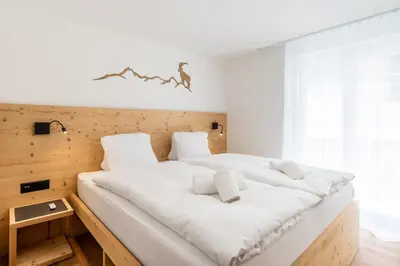 Ein Bett oder Betten in einem Zimmer der Unterkunft Alpines Bijou-Meiji Haus Juliana an der Bergbahn