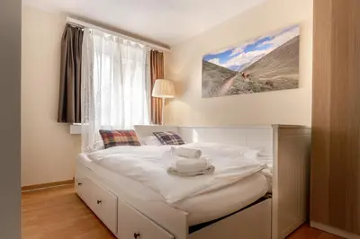 Ein Bett oder Betten in einem Zimmer der Unterkunft Alpenheim Apartment
