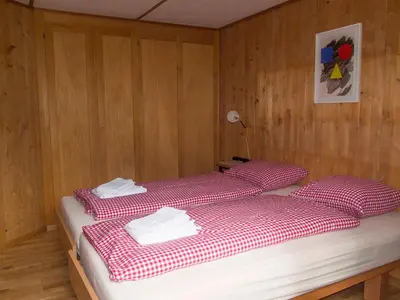 Ein Bett oder Betten in einem Zimmer der Unterkunft Ferienwohnung Chalet Zwirbeli