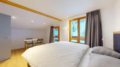 Ein Bett oder Betten in einem Zimmer der Unterkunft Chalet de l'Ours AUTHENTIC Appart Chambésy 6 pers