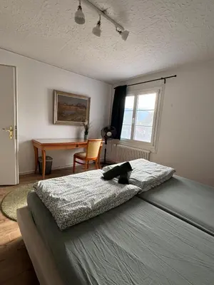Ein Bett oder Betten in einem Zimmer der Unterkunft Apartment Spiez - Lake view - for 7 guests