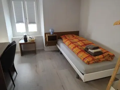 Ein Bett oder Betten in einem Zimmer der Unterkunft Ristorante con stanze Airolo