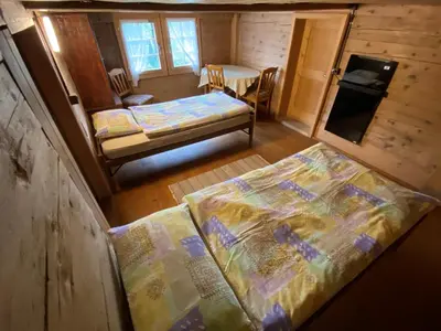 Ein Bett oder Betten in einem Zimmer der Unterkunft Ferienhaus Schönenmatte