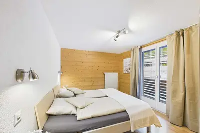 Ein Bett oder Betten in einem Zimmer der Unterkunft Vacation rental in Saas-Grund ideal for families