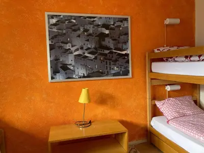 Ein Bett oder Betten in einem Zimmer der Unterkunft Apartment Chalet Sunnsyta by Interhome