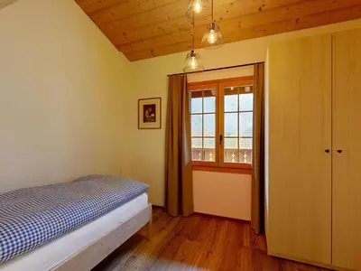 Ein Bett oder Betten in einem Zimmer der Unterkunft Apartment Chalet Wieseli by Interhome