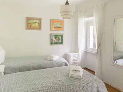 Ein Bett oder Betten in einem Zimmer der Unterkunft Holiday Home Palazzo Branca mit Blick auf den See- by Interhome