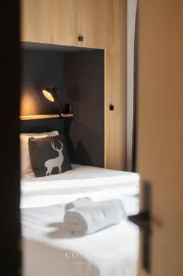 Ein Bett oder Betten in einem Zimmer der Unterkunft L'Ours des Pistes l Ski in-out l By CosyHome