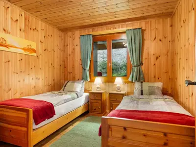 Ein Bett oder Betten in einem Zimmer der Unterkunft Chalet Als man zählte 1989 by Interhome