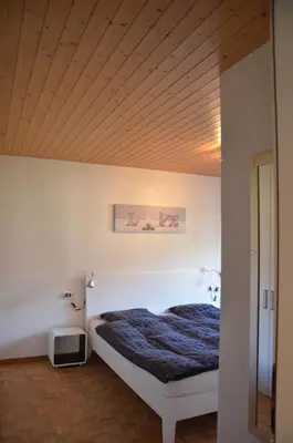 Ein Bett oder Betten in einem Zimmer der Unterkunft Ferienwohnung Sonnmatt