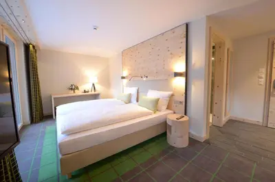 Ein Bett oder Betten in einem Zimmer der Unterkunft Alpenhotel Fleurs de Zermatt