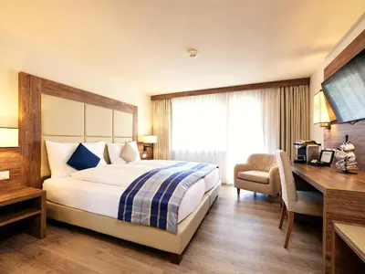 Ein Bett oder Betten in einem Zimmer der Unterkunft Hotel Ambassador Zermatt