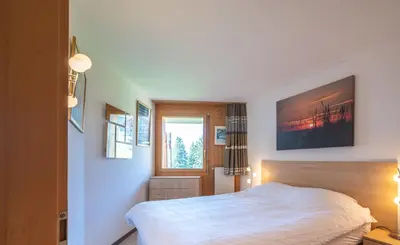 Ein Bett oder Betten in einem Zimmer der Unterkunft Eden Resort Anzère