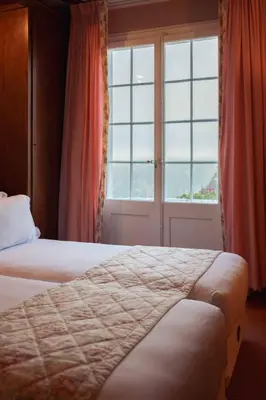 Ein Bett oder Betten in einem Zimmer der Unterkunft Hotel Regina