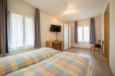 Ein Bett oder Betten in einem Zimmer der Unterkunft Hotel Alpenblick Mürren