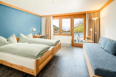 Ein Bett oder Betten in einem Zimmer der Unterkunft Ski-In/Ski-Out Hotel Sport
