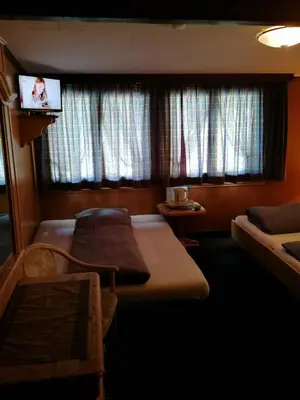 Ein Bett oder Betten in einem Zimmer der Unterkunft Petit Helvetia Budget Hotel