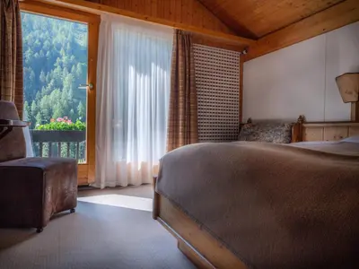 Ein Bett oder Betten in einem Zimmer der Unterkunft Hôtel Cristal - Swiss Riders Lodge Grimentz