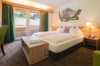 Ein Bett oder Betten in einem Zimmer der Unterkunft Hotel Restaurant Alpina