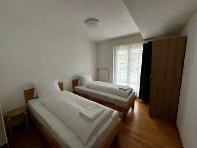 Ein Bett oder Betten in einem Zimmer der Unterkunft Swiss Holidays-City Apartments Interlaken