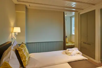 Ein Bett oder Betten in einem Zimmer der Unterkunft Hotel Spinne Grindelwald